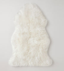 Ivory Sheepskin rug with thick merino wool fur, on a light gray background